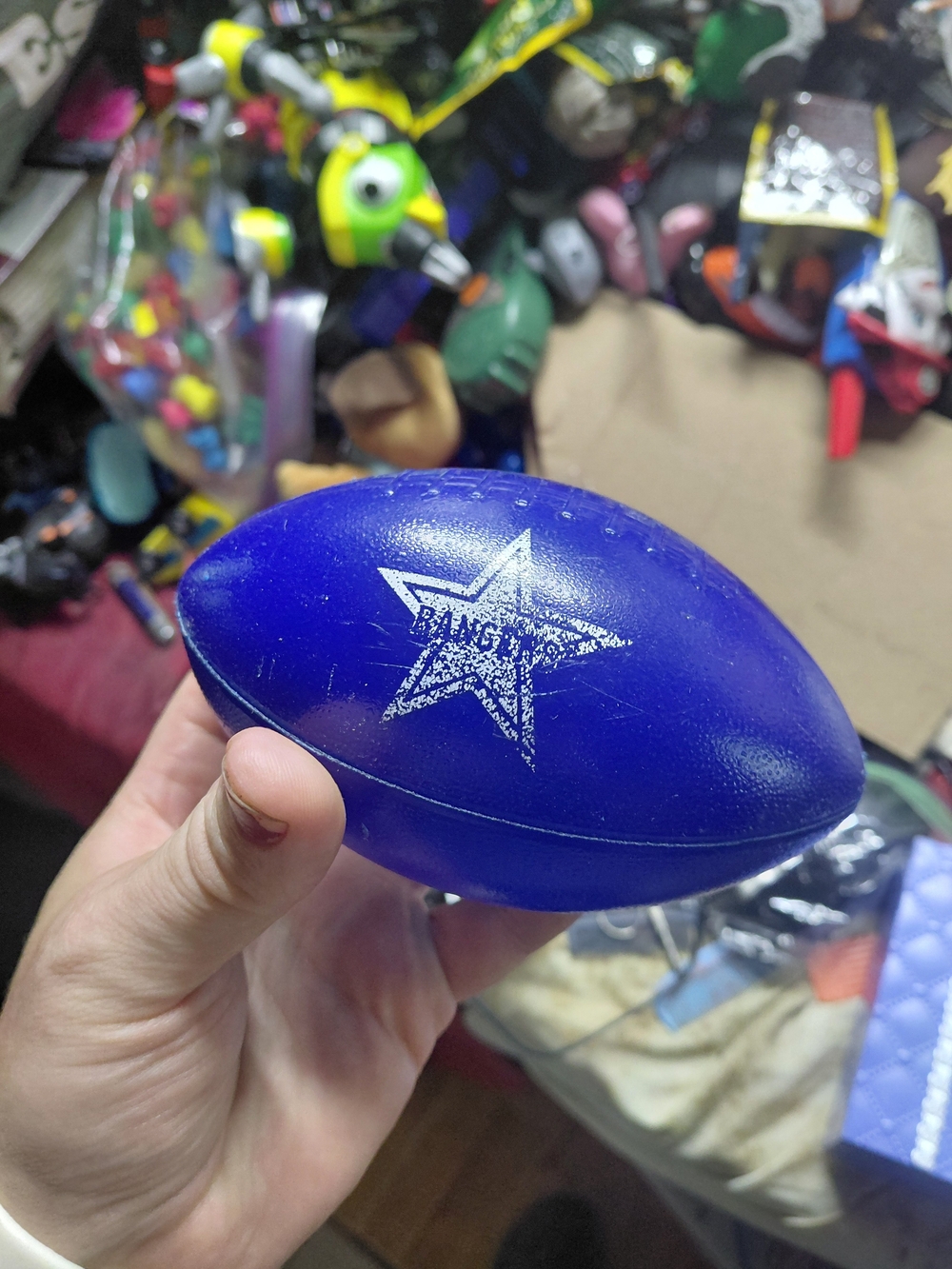 blue toy football features a Dallas Cowboys star logo on the side